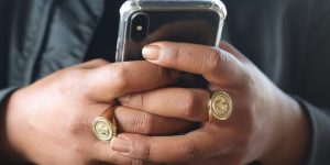 person holding gold and silver round coin