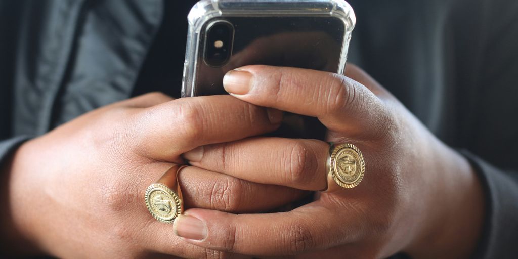 person holding gold and silver round coin