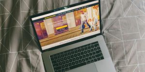 macbook pro on gray textile