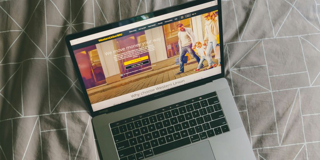 macbook pro on gray textile